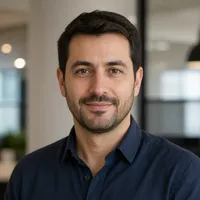Portrait of a professional author with a smart casual outfit, suitable for an editorial website. The person appears approacha